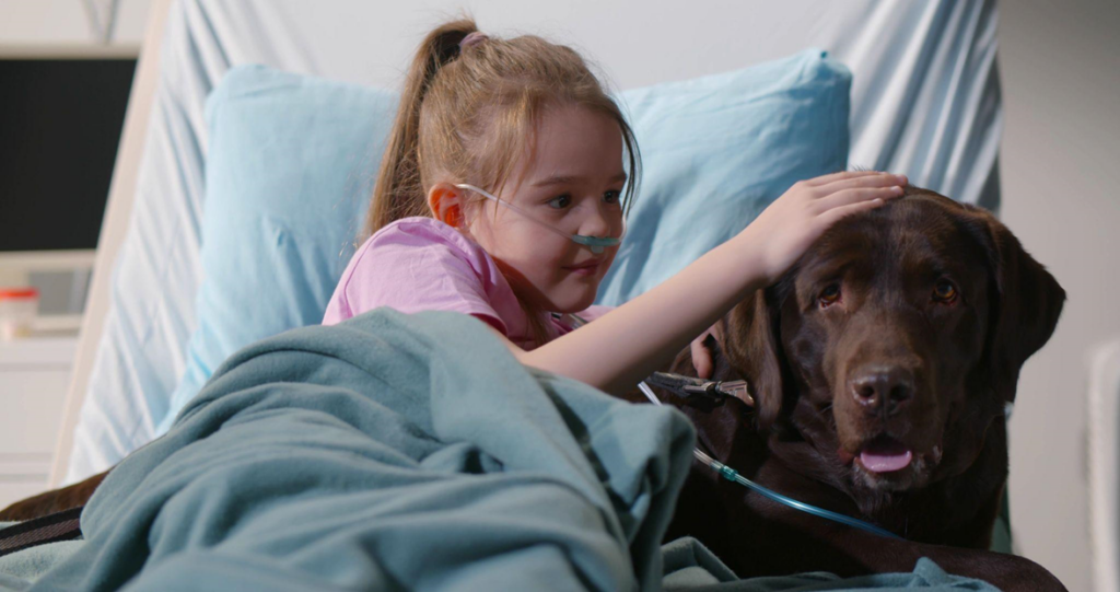 young girl petting therapy dog