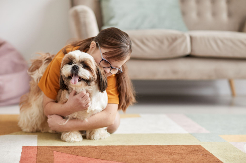 Kid hugging a dog at home