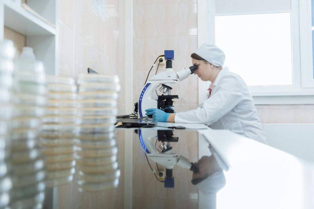 lady researcher looking through microscope